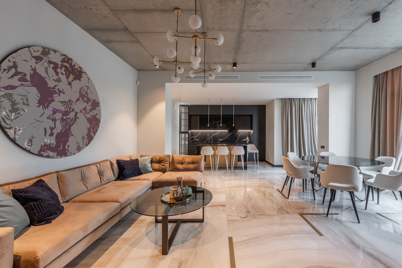 Studio interior with sofa near table and chairs near kitchen